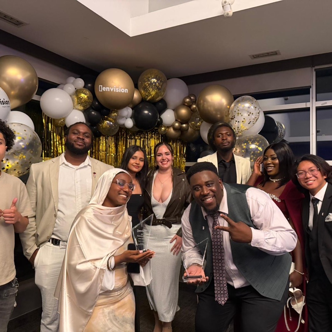 The full Legendz team in formalwear with two crystal awards at the Envision gala.