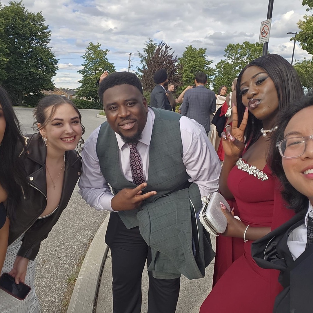Five team members in formalwear taking a selfie outside the gala venue.